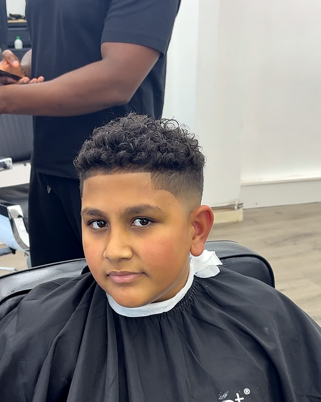 Curly top with a taper fade