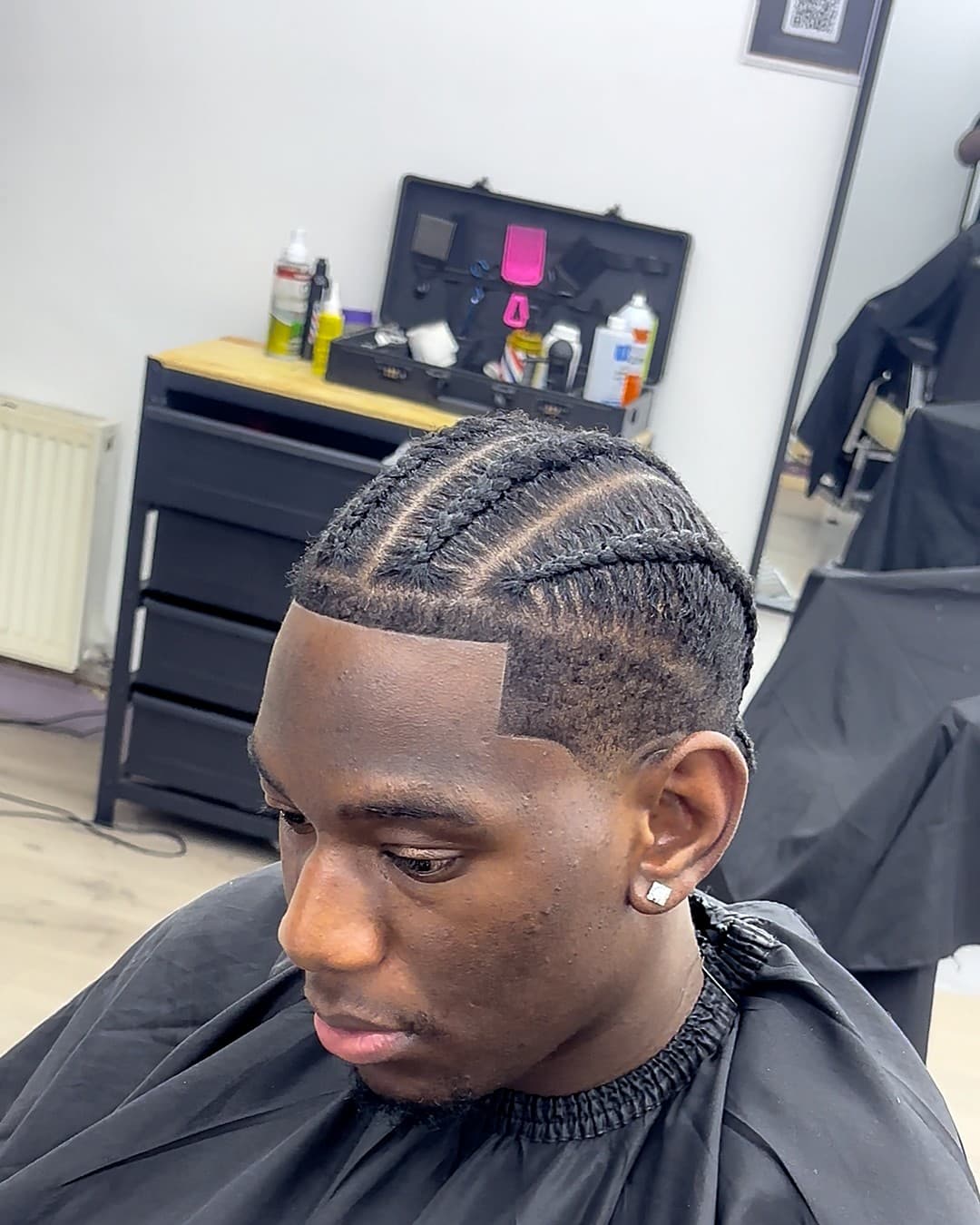 Cornrows with a part design and taper