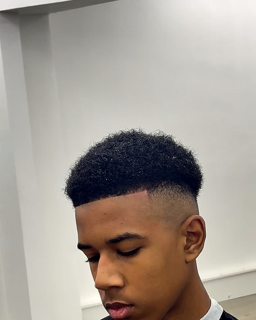 Afro with a clean drop fade